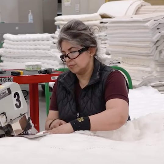 Woman sewing a mattress