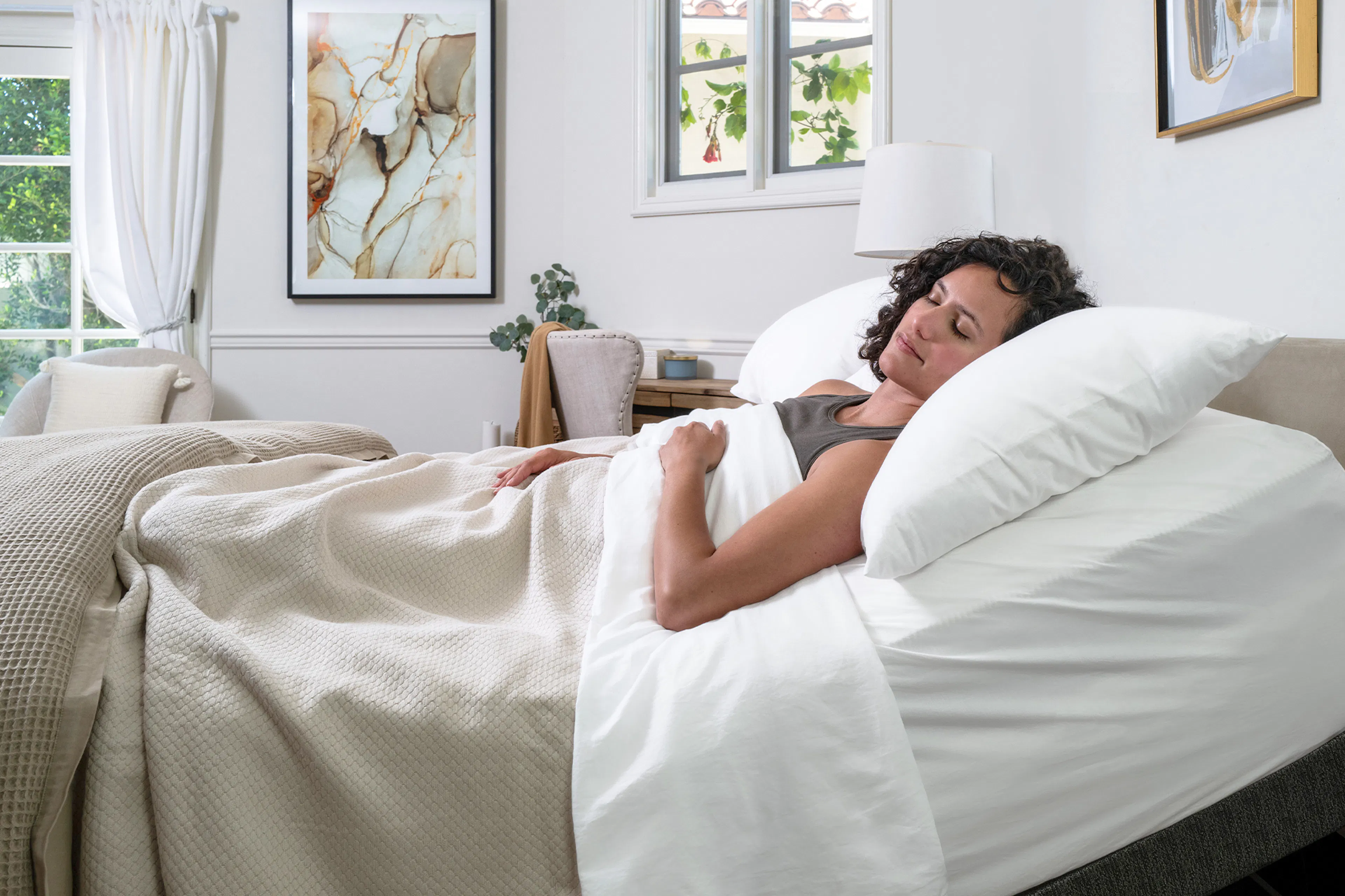 Bed with white mattress and clean modern bedroom setup