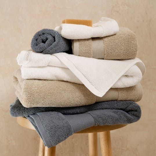 Plush towels stacked on a stool