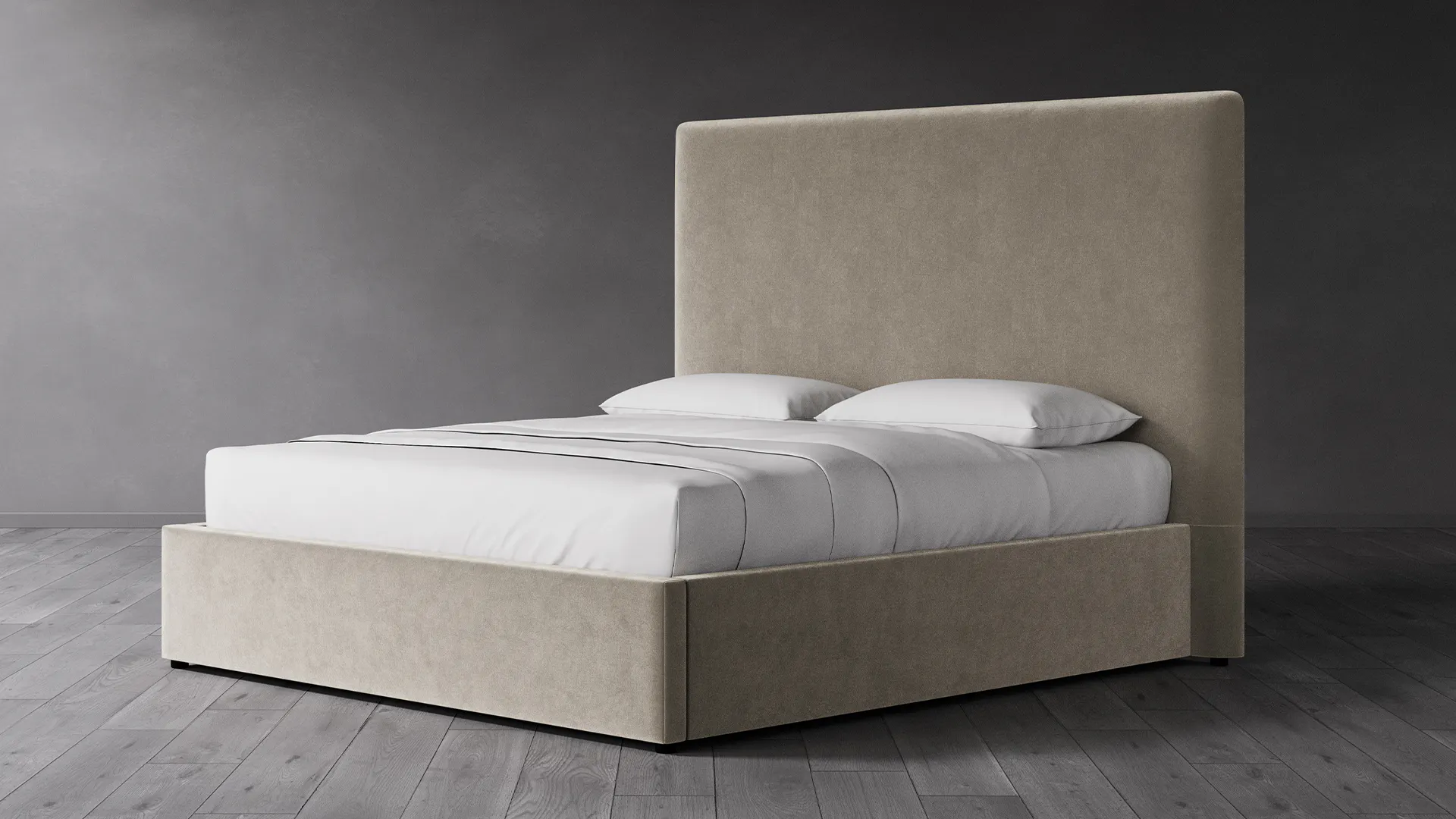 A low-profile beige upholstered bed with a tall headboard and matching footboard in a minimalist bedroom setting
